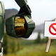 Master Chief turns away from a "banned" sign on an alien planet.